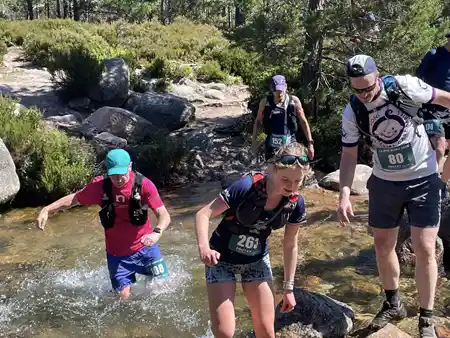 Runners crossing a stream on the Larig Grhu Ultra marathon