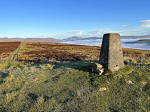 Over the Carman : The trig point with Ben Lomond in the background